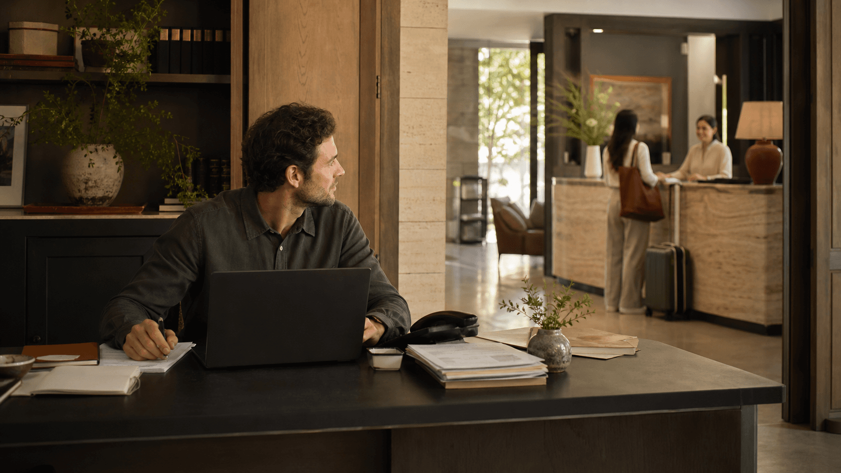 Hotel operations manager working across the back office and reception